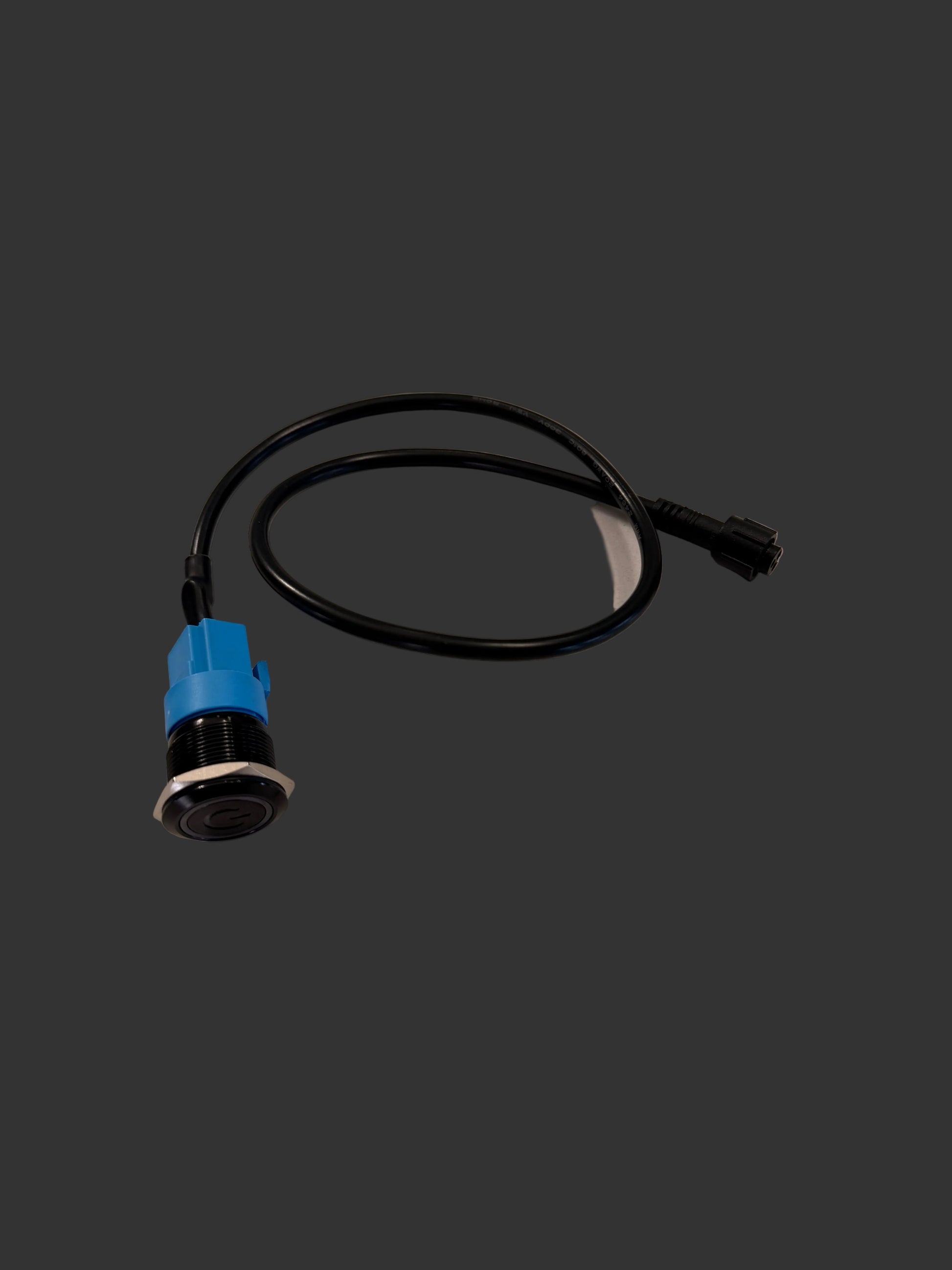 Black cable with blue connector on a white marble surface